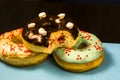 Set of assorted donuts with blue glaze, sprinkle, chocolate and marshmallows close-up  on a pink background. Sweet food Royalty Free Stock Photo