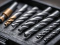 Set of assorted metal drill bits arranged neatly in a toolbox with varying sizes and sharp spiral grooves for industrial and Royalty Free Stock Photo