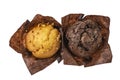 Set of assorted muffins in brown paper isolated on white background, top view Royalty Free Stock Photo