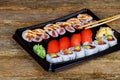Set of assorted sushi served plastic box on wooden table Royalty Free Stock Photo