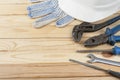 Construction tools ,white helmet and work gloves on wooden background. Copy space for text.
