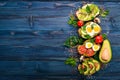 A set of avocado sandwiches, cherry tomatoes and quail eggs and chia seeds. On a wooden background. Royalty Free Stock Photo