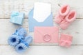 Set of baby girl and boy booties and greeting card form. Top view Royalty Free Stock Photo