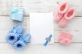 Set of baby girl and boy booties and greeting card form. Top view Royalty Free Stock Photo