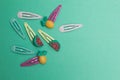 Set of baby hair pins on a green background