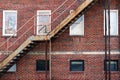 back alley rusted stairs window brick building