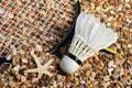 Set Badminton racket and shuttlecock feathers on rocks, beach background. Royalty Free Stock Photo