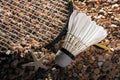 Set Badminton racket and shuttlecock feathers on rocks, beach background. Royalty Free Stock Photo