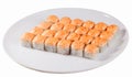 Set of baked sushi rolls on an oval plate isolated white background, orange beanie hat cap Royalty Free Stock Photo