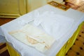 A set of baptismal clothes and a towel on the table in the church. Royalty Free Stock Photo