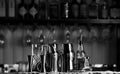 Set of bar accessories for making cocktails, located on the bar, behind is a shelving with liqueurs and strong alcohol. Royalty Free Stock Photo