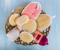 A set of bath sponges from a loofah with soap, a towel and shampoo in a basket Royalty Free Stock Photo