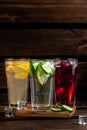 Set of beautiful summer refreshing drinks on a wooden background. still life composition with three glasses of red, yellow and Royalty Free Stock Photo