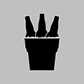 Set of beer bottles in a metal bucket with ice cubes. Black silhouette with white linear outline. Vector drawing and simple icon. Royalty Free Stock Photo