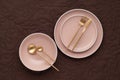 A set of beige plates of different sizes on the table, top view. Golden cutlery, serving utensils. Modern trendy ceramic tableware Royalty Free Stock Photo