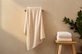 A set of beige terry towels. The towel is hanging on the crossbar