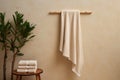 A set of beige terry towels. The towel is hanging on the crossbar