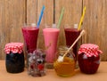 Set of berry smoothies, jams and frozen berries Royalty Free Stock Photo