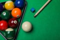 Set of billiard balls with rack, cue and chalk on green table, flat lay. Space for text Royalty Free Stock Photo