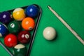 Set of billiard balls with rack and cue on green table, flat lay Royalty Free Stock Photo