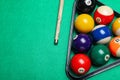Set of billiard balls with rack and cue on green table, flat lay. Space for text Royalty Free Stock Photo