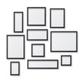 Set of Black Blank Picture Frames, hanging on a White Wall from Royalty Free Stock Photo