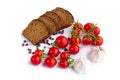 Set of black bread, cherry tomatoes and garlic Royalty Free Stock Photo