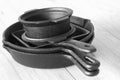 Set of  black cast iron pots and pans on grey wood Royalty Free Stock Photo