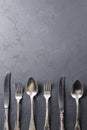 Set of black cutlery: fork, spoon, and knife. Placed over black background, table setting. Copy space banner Royalty Free Stock Photo