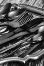 Set of black cutlery tableware on an antique silver tray. Royalty Free Stock Photo