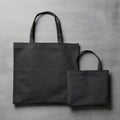 Set Of Black Fabric Shopping Bags In Different Sizes On Concrete Background. Black Tote Bags Mock-Up Collection Royalty Free Stock Photo