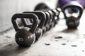 Set of black kettlebells on wooden floor