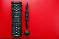 Set of Black lumpy foam massage roller, body roller, rubber ball on red background Royalty Free Stock Photo