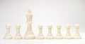 Set of black & white chess figures on white background. White king chess with others white isolate with text space for business