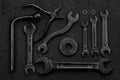 Set of black & white repair tools on black background