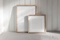 Set of blank vertical and square wooden picture frame mock ups in sunlight. White beadboard wainscot wall paneling Royalty Free Stock Photo