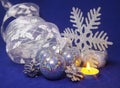 set blue beautiful glass New Year`s balls, brilliant tinsel, the burning candle on a blue background - New Year`s composition, Royalty Free Stock Photo