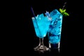 Set of Blue Curacao cocktails garnished with a lime isolated on black background Royalty Free Stock Photo