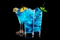 Set of Blue Curacao cocktails garnished with a lime isolated on black background Royalty Free Stock Photo