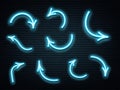 Set of blue neon arrows glowing on dark brick wall background