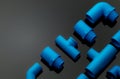 Set of blue PVC pipe fittings isolated on dark background. Blue plastic water pipe. PVC accessories for plumbing. Plumber Royalty Free Stock Photo