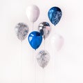 Set of blue and silver glossy balloons on the stick with sparkles on white background. 3D render for birthday, party, wedding or p