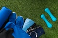 Set of blue things for sports man training lies on green grass background Royalty Free Stock Photo