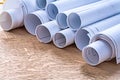 Set of blueprint rolls on wooden oaken board Royalty Free Stock Photo