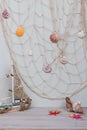 Set of boat, fishing net, starfish and seashells stand on light gray background. Royalty Free Stock Photo