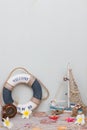 Set of boat, fishing net, starfish and seashells stand on a light gray background. Summer time Royalty Free Stock Photo