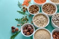 Set of bowls with organic quinoa, lentil, chickpea, wheat, walnut, almond, hazelnut and sesame. Cereals and legumes assortment on