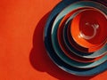 Set of bowls and plates are arranged in a stack on a red background Royalty Free Stock Photo