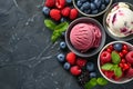 Set of bowls with various colorful Ice Cream scoops with different flavors and fresh ingredients on black background, top view. Royalty Free Stock Photo