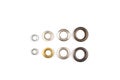 Set of brass multicoloured metal eyelets or rivets - curtains rings for fastening fabric to the cornice, isolated on Royalty Free Stock Photo